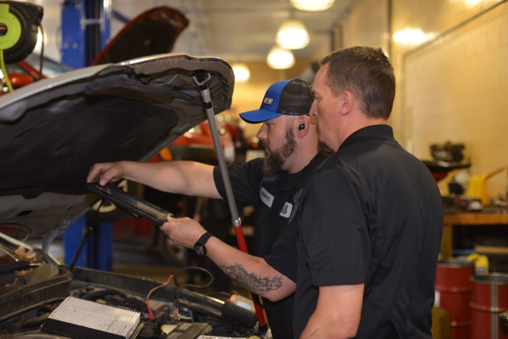 Technicians performing an Oil Change