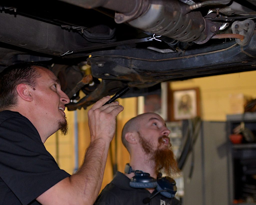 Technicians performing Vehicle Inspection