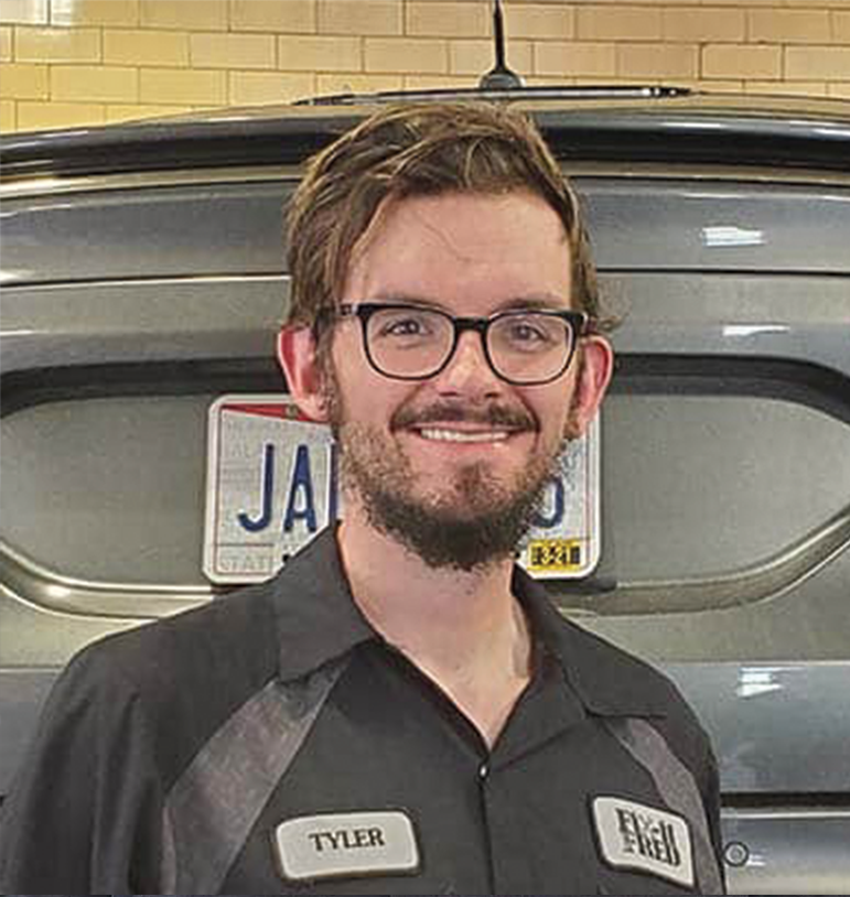 Tyler Orall in garage at Fix-it With Fred